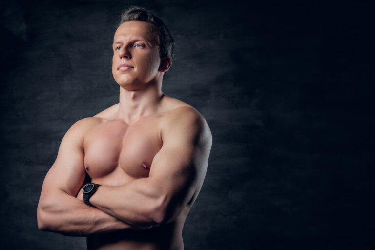 bodybuilder chest growth in dark background