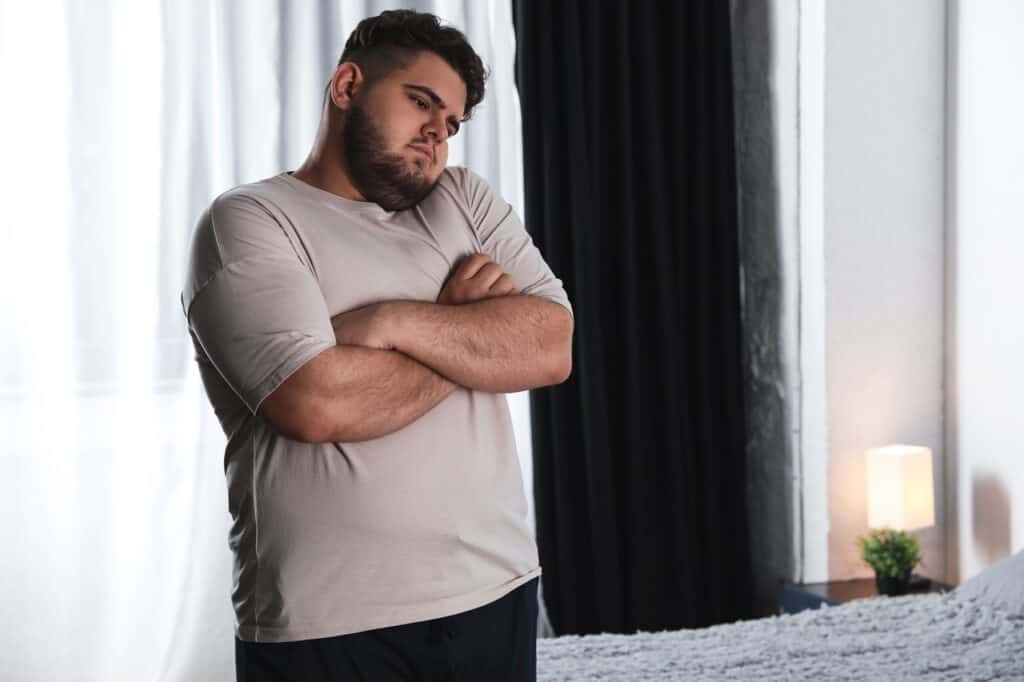 obese male arms crossed