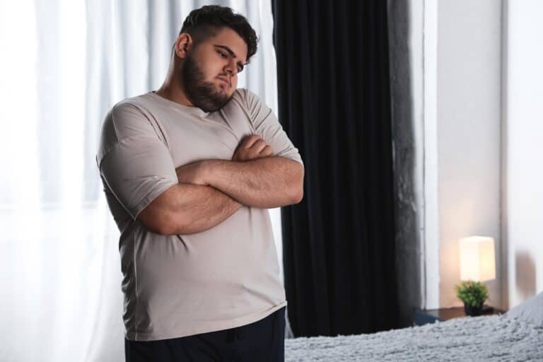 obese male arms crossed